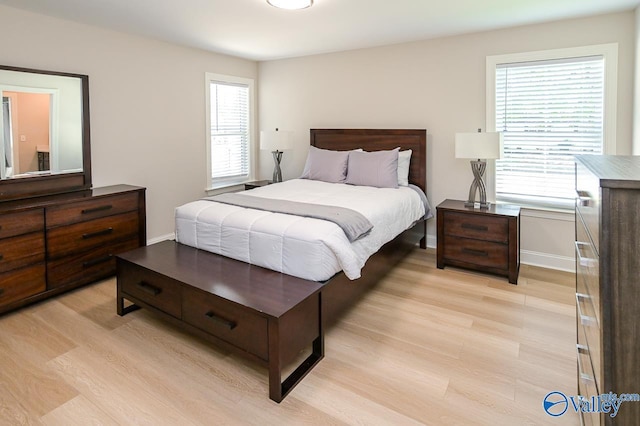 bedroom featuring multiple windows and light hardwood / wood-style floors