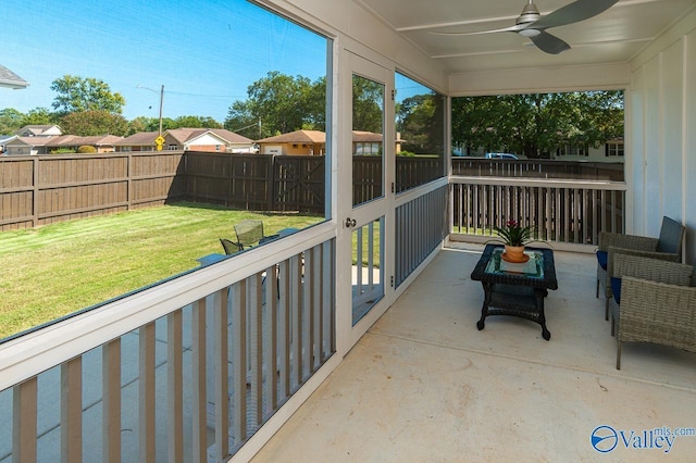 sunroom featuring ceiling fan