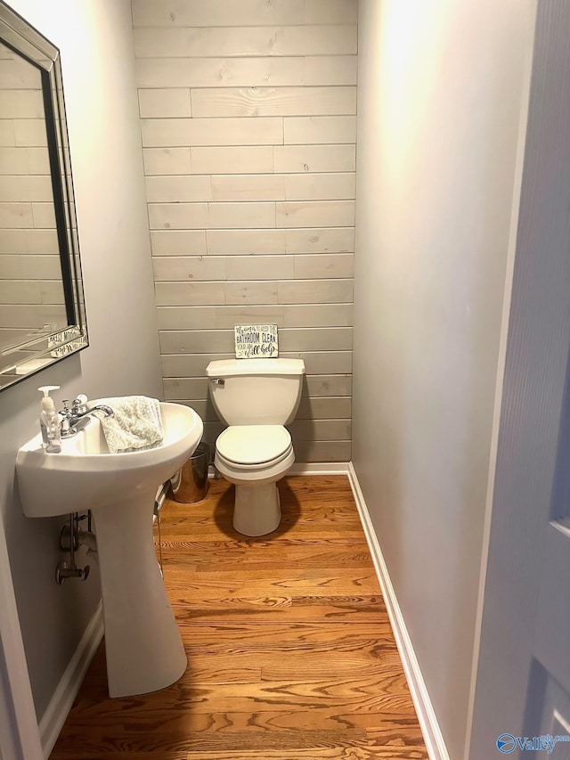 173 N Seneca Dr, Trinity, AL 35673 - half bath with wood finished floors, toilet, and baseboards