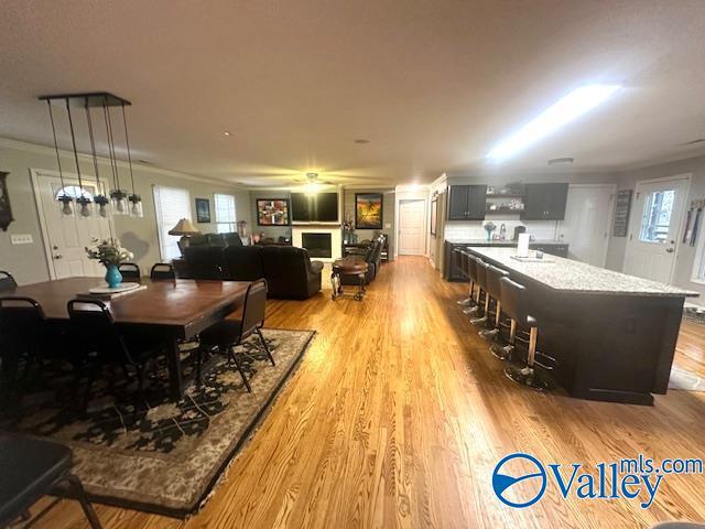 173 N Seneca Dr, Trinity, AL 35673 - dining area featuring wood finished floors and crown molding