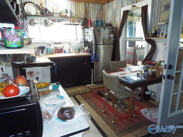 kitchen featuring stainless steel refrigerator and a wealth of natural light