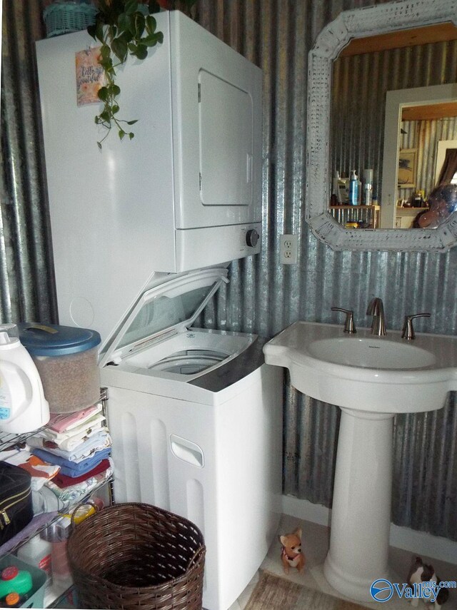 laundry room featuring stacked washer / drying machine