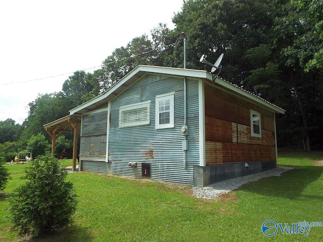 view of side of home with a lawn