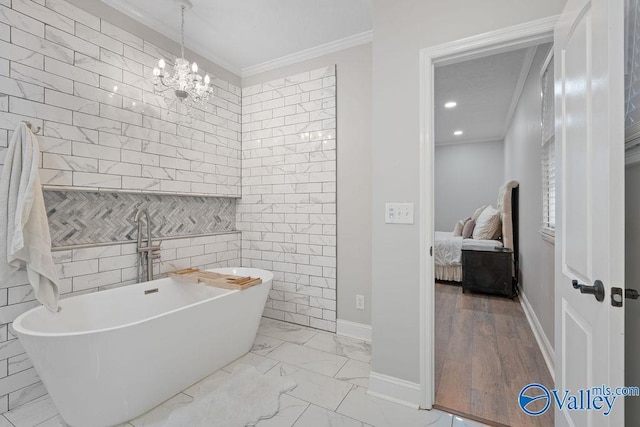 bathroom with tile walls, a notable chandelier, crown molding, and a bath