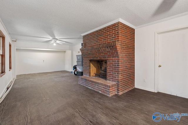 unfurnished living room featuring a textured ceiling, a brick fireplace, dark hardwood / wood-style floors, ornamental molding, and ceiling fan