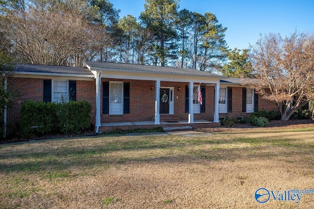 ranch-style house with covered porch and a front lawn