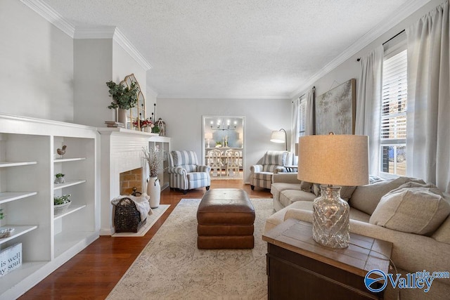 living room with a textured ceiling, ornamental molding, and wood-type flooring