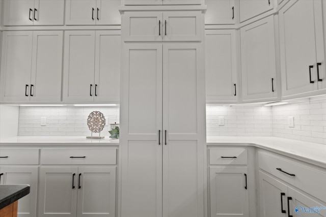 22692 Gunner Cir, Athens, AL 35613 - kitchen with white cabinetry, backsplash, and light countertops