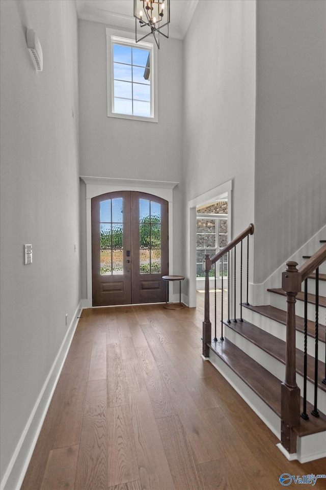 22692 Gunner Cir, Athens, AL 35613 - foyer entrance with wood finished floors, a chandelier, french doors, stairway, and crown molding