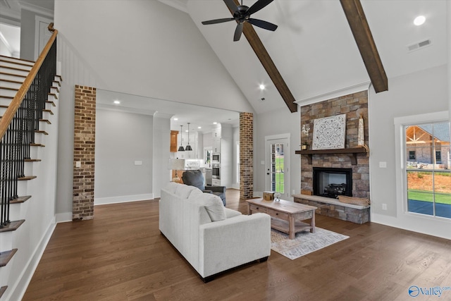 22692 Gunner Cir, Athens, AL 35613 - living area with high vaulted ceiling, a stone fireplace, a ceiling fan, dark wood-style flooring, and stairs