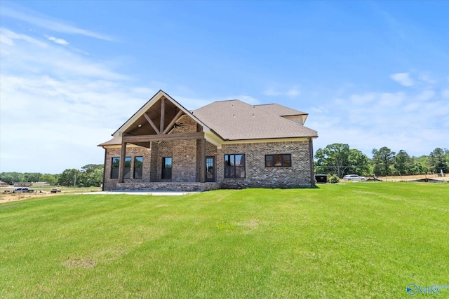22692 Gunner Cir, Athens, AL 35613 - rear view of house featuring a yard, brick siding, and a shingled roof