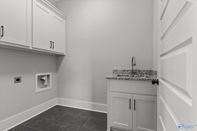 22692 Gunner Cir, Athens, AL 35613 - laundry area featuring hookup for an electric dryer, cabinet space, baseboards, and washer hookup