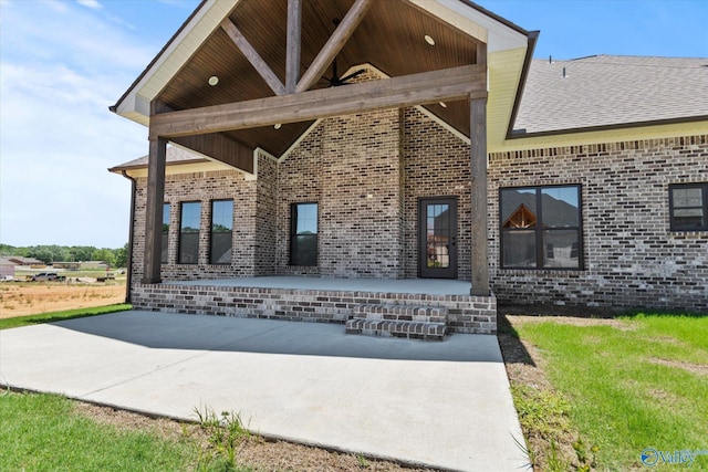22692 Gunner Cir, Athens, AL 35613 - back of property with a patio area, brick siding, and a shingled roof