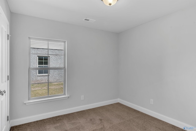 carpeted empty room with baseboards and visible vents