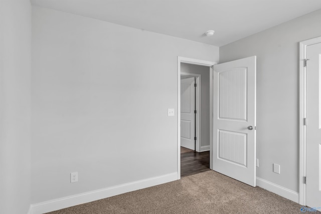 unfurnished bedroom with baseboards and carpet flooring