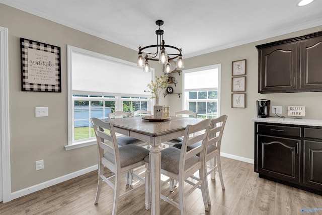 dining area featuring light wood-type flooring, a chandelier, and a wealth of natural light