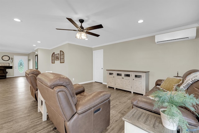 living room featuring ceiling fan, a wall unit AC, light hardwood / wood-style flooring, and ornamental molding