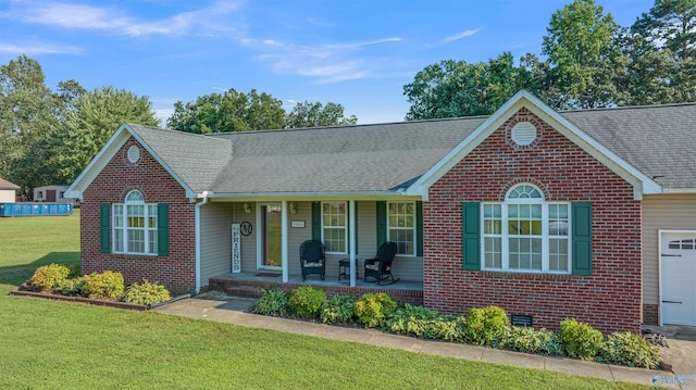 single story home with a front lawn, a garage, and a porch