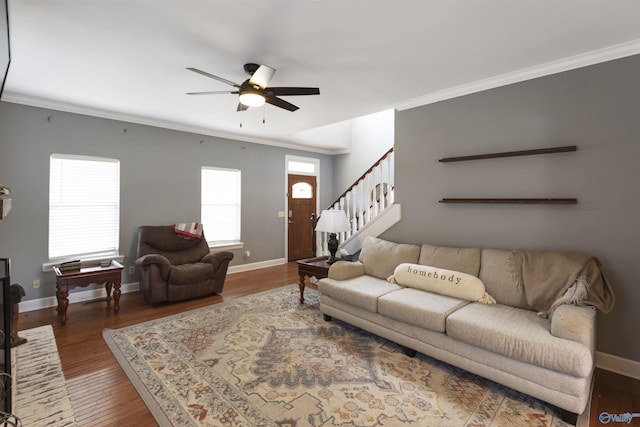 living room featuring hardwood / wood-style floors, ceiling fan, and crown molding