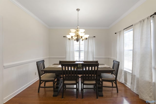 dining space with ornamental molding, an inviting chandelier, and dark wood-type flooring