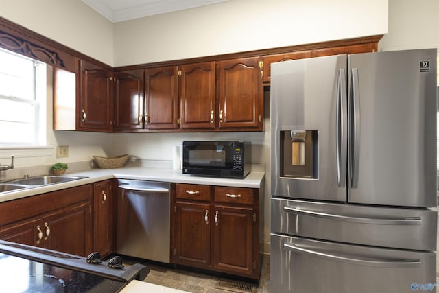 kitchen featuring sink, crown molding, and appliances with stainless steel finishes