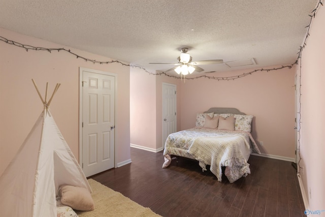 bedroom with a textured ceiling, ceiling fan, and dark wood-type flooring