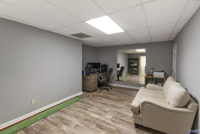 office area with light hardwood / wood-style flooring and a drop ceiling