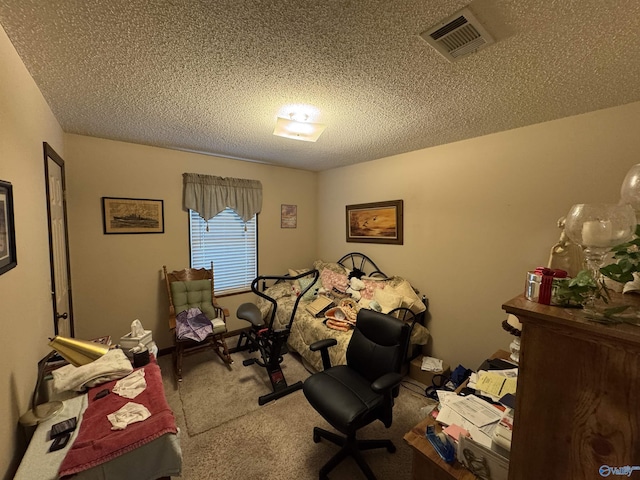 bedroom featuring a textured ceiling, carpet flooring, and visible vents