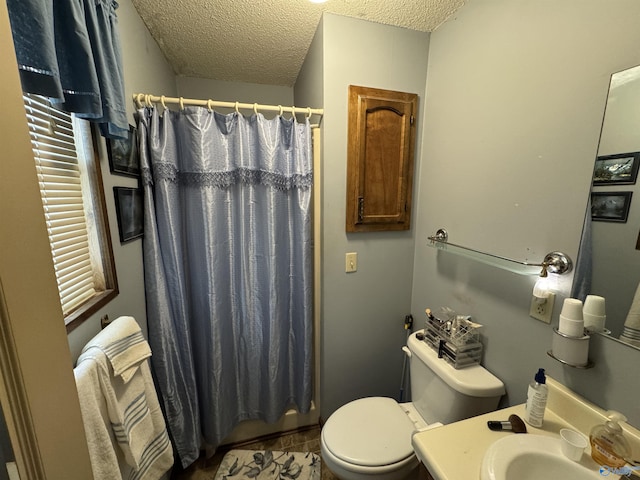 bathroom with toilet, a textured ceiling, a shower with curtain, and vanity