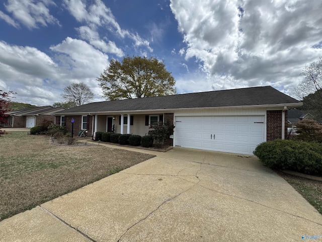 ranch-style house featuring brick siding, driveway, an attached garage, and covered porch