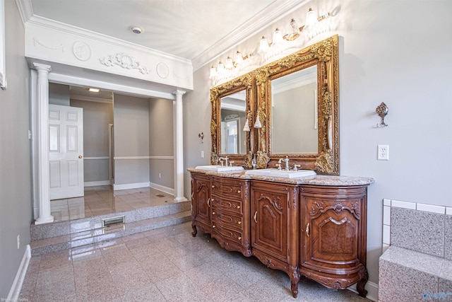 bathroom with crown molding, vanity, and ornate columns