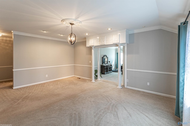 carpeted empty room with lofted ceiling, a notable chandelier, ornamental molding, and ornate columns