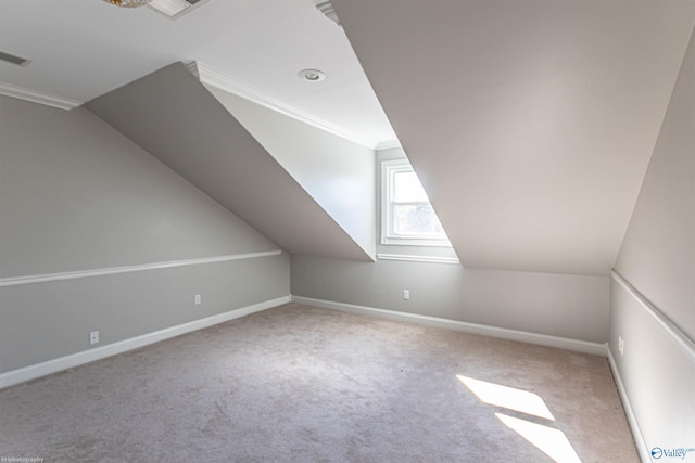 bonus room featuring vaulted ceiling and light colored carpet