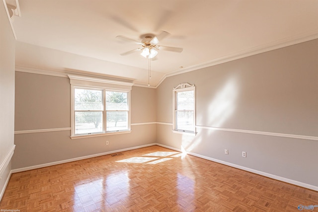 spare room with ceiling fan, vaulted ceiling, ornamental molding, and light parquet flooring