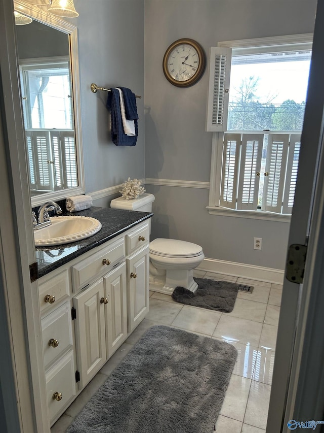 bathroom with vanity, a wealth of natural light, and tile patterned floors