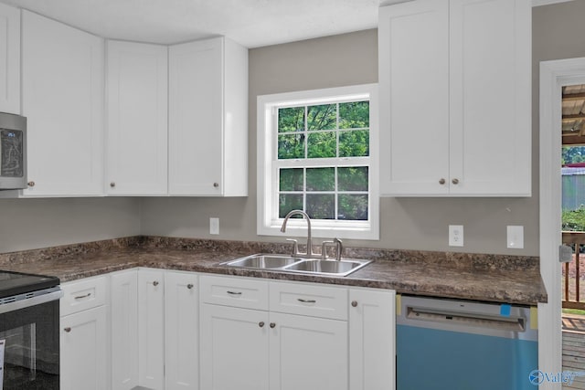 2221 Old Union Rd, Grant, AL 35747 - kitchen with dishwashing machine, a sink, stainless steel range with electric stovetop, dark countertops, and white cabinetry