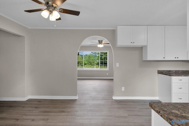 2221 Old Union Rd, Grant, AL 35747 - kitchen with ceiling fan, light wood-style floors, baseboards, arched walkways, and white cabinetry