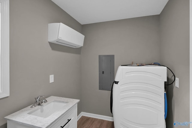 2221 Old Union Rd, Grant, AL 35747 - bathroom with electric panel, a wall mounted air conditioner, washer / dryer, wood finished floors, and baseboards