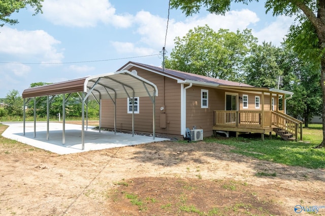 2221 Old Union Rd, Grant, AL 35747 - back of house with a detached carport, a cooling unit, dirt driveway, and a wooden deck