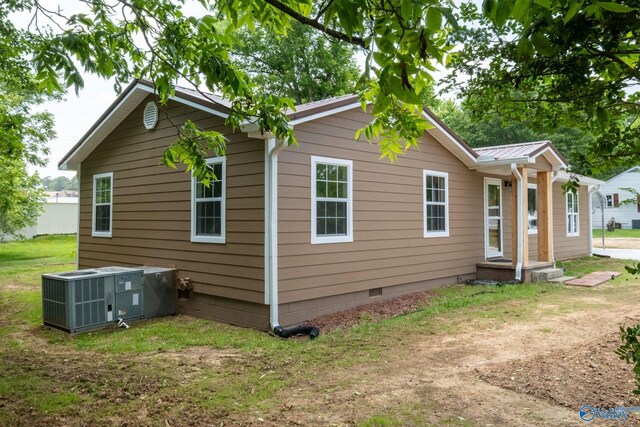 2221 Old Union Rd, Grant, AL 35747 - view of home's exterior with crawl space, central AC unit, metal roof, and a yard