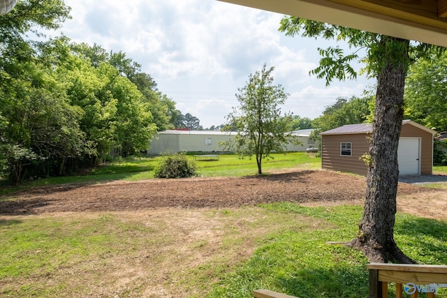 2221 Old Union Rd, Grant, AL 35747 - view of grassy yard with an outdoor structure and a garage