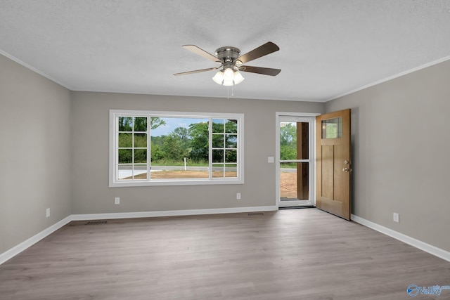 2221 Old Union Rd, Grant, AL 35747 - spare room featuring ceiling fan, wood finished floors, a textured ceiling, baseboards, and crown molding