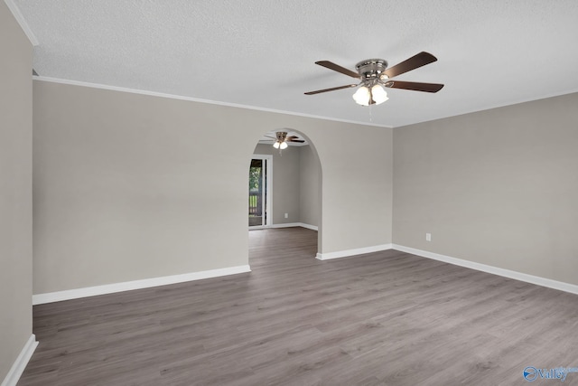 2221 Old Union Rd, Grant, AL 35747 - spare room featuring ceiling fan, arched walkways, wood finished floors, a textured ceiling, and baseboards
