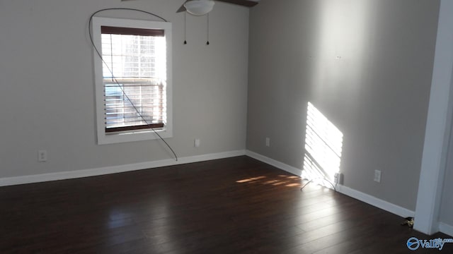 empty room featuring ceiling fan and dark hardwood / wood-style flooring