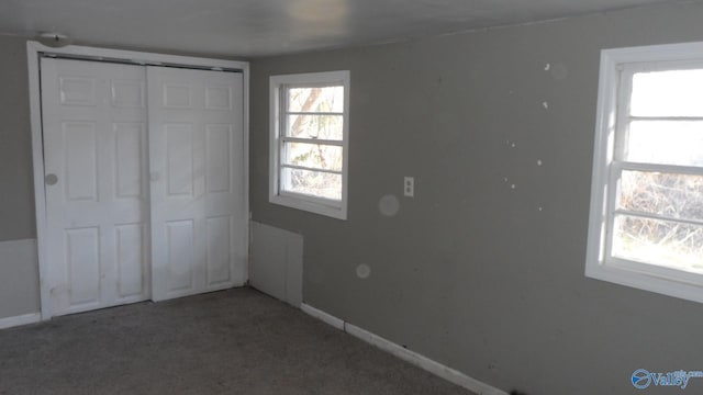 unfurnished bedroom with carpet flooring and a closet