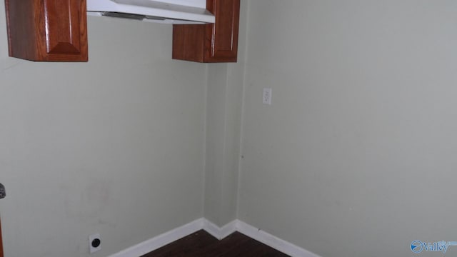 washroom featuring dark wood-type flooring and hookup for an electric dryer