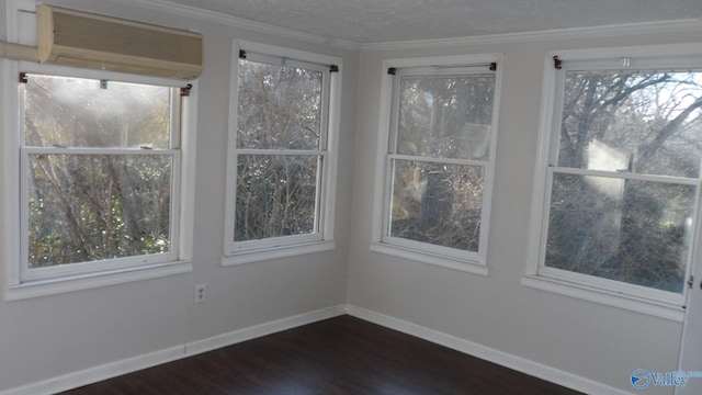 unfurnished sunroom with a wall mounted air conditioner