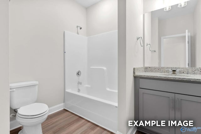 full bathroom with hardwood / wood-style floors, vanity, toilet, and tub / shower combination