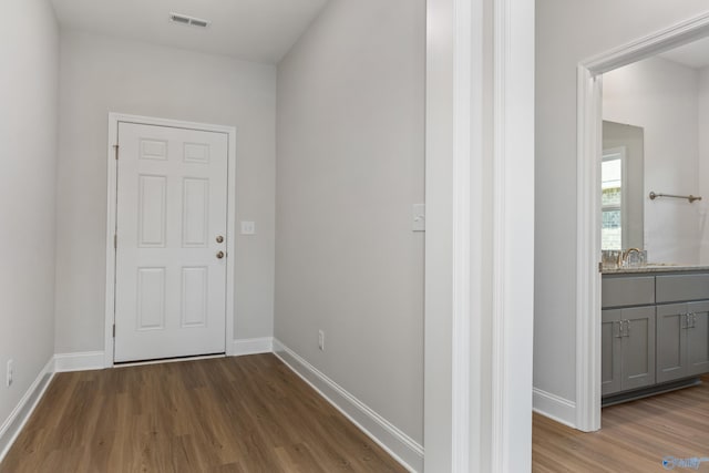 hall with dark hardwood / wood-style floors and sink