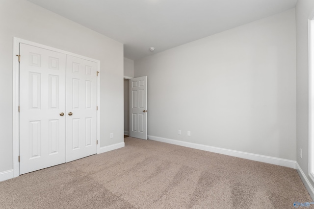 unfurnished bedroom featuring a closet and carpet